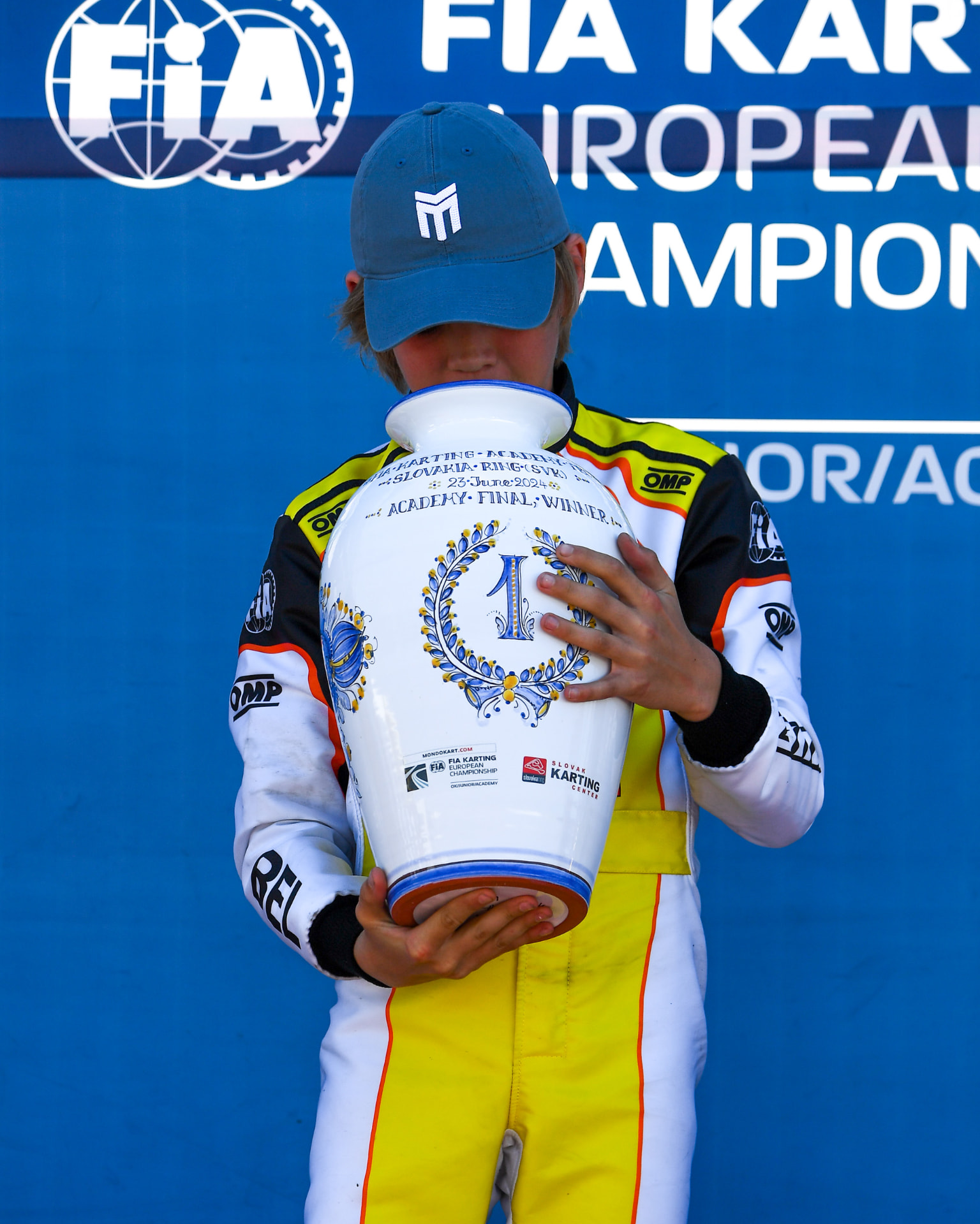 Gilles holding the Academy Final winner's trophy